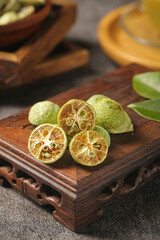 Freeze-Dried Kumquat Citrus Fruits on Wooden Tray - Premium Quality Healthy Snack and Tea Ingredient