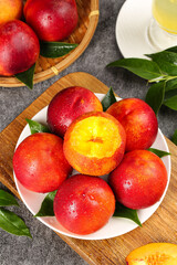 Fresh Red and Yellow Nectarines on White Plate with Green Leaves - Dalian Shanxi Stone Fruit