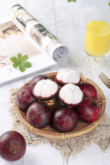 Fresh Thai Mangosteen Tropical Fruit with White Flesh in Bamboo Basket Thailand