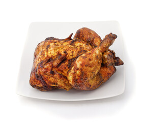 Roast chicken on white plate isolated on white.