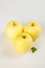 Fresh Natural Golden Apples from Xinjiang China with Mint Leaf on White Background