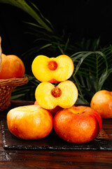 Fresh Cut Shandong Peaches with Golden Flesh on Dark Slate Board