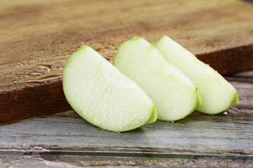 Fresh Green Apple Slices on Wooden Cutting Board - Crisp Sweet Fruit