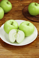 Fresh Green Apples from Shaanxi China on Wooden Table with Cut Apple Half