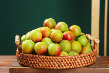 Fresh Colorful Plums in Wicker Basket on Wood Table - Organic Fruit Harvest Display