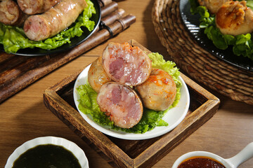 Authentic Mongolian wrapped meat rolls with pork and lamb belly on wooden tray - Inner Mongolia cuisine specialties