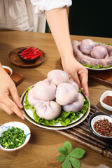 Traditional Mongolian sheep meat specialties - fresh raw mutton buns and belly cuts with herbs for authentic Inner Mongolia cuisine