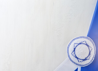 Independence Day of Israel. National Israel flag and Jewish kippahwith star of David over white wooden background. Close up. National flag with place for text. Element for design.