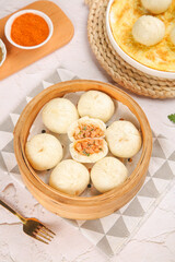 Fresh Xiao Long Bao Chinese Dumplings in Bamboo Steamer with Meat Filling and Chili Sauce