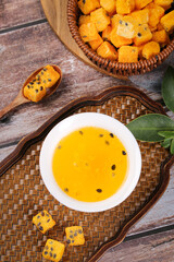 Making passion fruit tea with dried freeze fruit cubes instant herbal drink healthy tropical beverage wooden rustic background