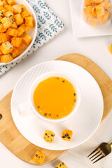 Passion Fruit Tea with Freeze Dried Chunks - Instant Tropical Herbal Beverage in White Cup on Wood Board
