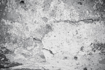 Cracked concrete wall covered with gray cement surface. Grey old wall with shabby damaged plaster or cement and brick background of an vintage dirty exfoliating plaster. Mock up.