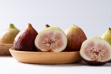 Fresh fig on wooden plate with white background, Autumn fruit