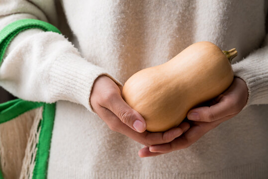 Butternut squash pumpkin holding by woman hand