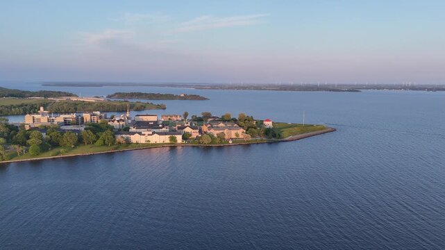 Drone view of the Royal Military College campus on a tree-lined peninsula in Kingston, Ontario