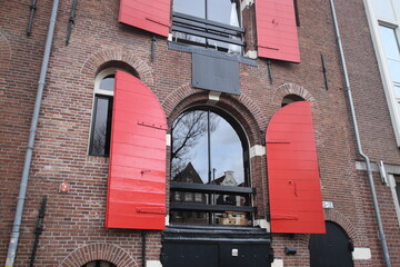 facade of a building with red windows, old warehouse in Amsterda