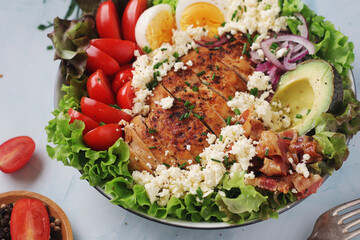 A bowl with cobb salad, traditional American dish