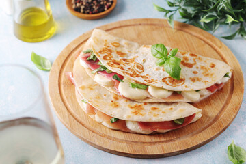 Traditional Italian dish Piadina romagnola - flat bread with mozarella and proscuitto