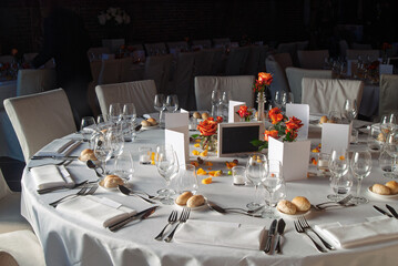 Elegant table settings with fine glassware, decorative flowers, and formal arrangements ideal for special occasions or events in a sophisticated and tasteful ambiance.