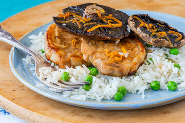 Orange glazed pork escalopes and portobello mushrooms with rice