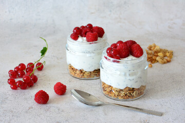 Healthy Breakfast Parfaits with red currant and raspberry and Granola and a spoon
