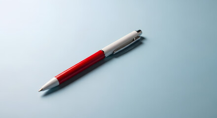 Fototapeta premium Elegant red and white pen on a blue background minimalist design office supply