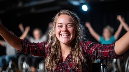A young woman in a wheelchair beams with joy while dancing, showcasing the beauty of adaptive movement and the power of self-expression in an inclusive environment.