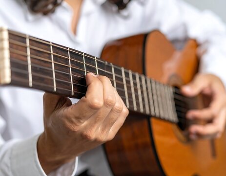 Close-up of hands playing an acoustic guitar