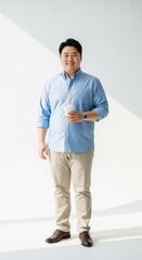 Fototapeta premium Asian Chubby Man in Business Casual Attire Holding Coffee