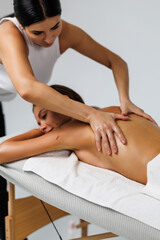 Close-up of masseur's hands and a client's back. Healthcare