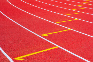 Fototapeta premium Empty running tracks at an outdoor athletics stadium featuring distinctive white lines and curves