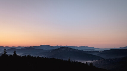 majestic mountain sunrise with mist and forest (horizontal) © irenka