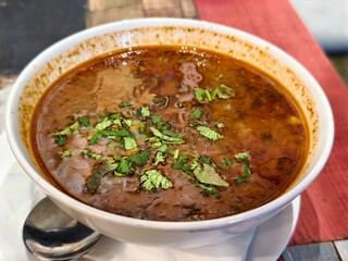 Bowl of delicious homemade soup garnished with fresh cilantro ready to be served and enjoyed today