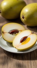 Ripe Canistel Fruit (Eggfruit) Halves on White Plate, revealing creamy yellow flesh and seed, with whole tropical fruits on a rustic wooden table under natural light, close-up.