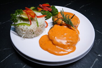 Gourmet Dish with Creamy Sauce, Rice, and Vegetables