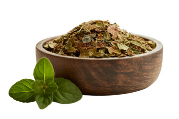 Fototapeta premium A rustic wooden bowl of coarse, dried basil or mint leaves, with a fresh green sprig of the herb, isolated on a white background.
