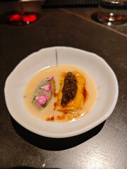 Exquisite seafood dish featuring caviar and delicate flower petals served in a fine dining restaurant