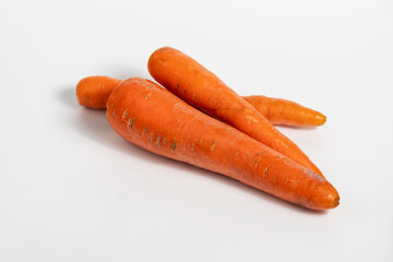 pile of fresh carrots isolated on white background