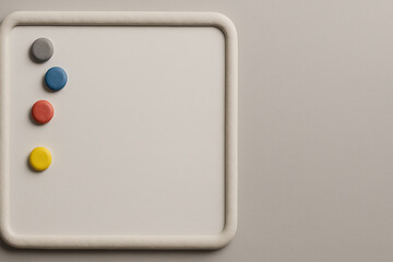 Close-up of a white board with four colorful magnets on the left side.