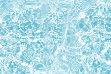 Blue water with ripples on the surface. Defocus blurred transparent blue colored clear calm water surface texture with splashes and bubbles. Water waves with shining pattern texture background.