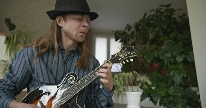 Male Musician Plays Mandolin. Caucasian Man Enjoys Playing Music 4K 10-bit
