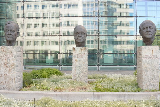 Fathers of Unity: Busts of Cold War world leaders George H. W. Bush, Helmut Kohl, and Mikhail Gorbatschow stand in front of the Axel Springer building, Berlin
