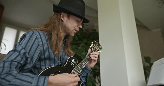 Male Musician Plays Mandolin. Caucasian Man Enjoys Playing Music 4K 10-bit