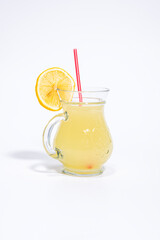 Homemade lemonade. Lemonade in a glass vase. Delicious handmade lemonade. Lemonade glass on a white background.
