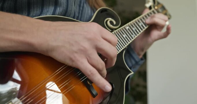 Male Musician Plays Mandolin. Caucasian Man Enjoys Playing Music 4K 10-bit