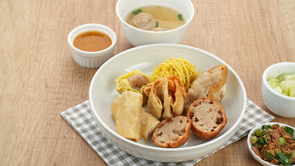 Bakso Malang, meatball soup with tofu, fried shumay, noodles and dumplings. Served with sambal and cucumber