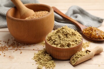 Different types of mustard on wooden table, closeup