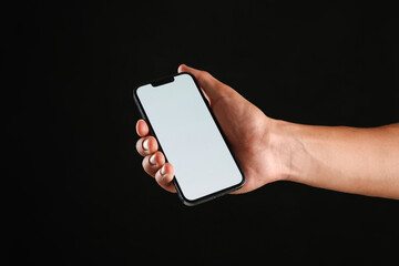 Man with modern smartphone on black background, closeup. Mockup for design