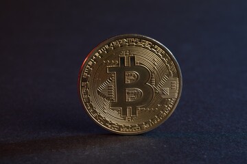 Cryptocurrency. Bitcoin on blue background, closeup view