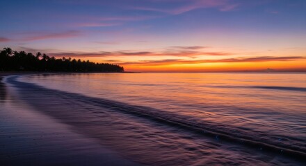 A serene beach at dusk with palm trees silhouetted against an orange and purple sky